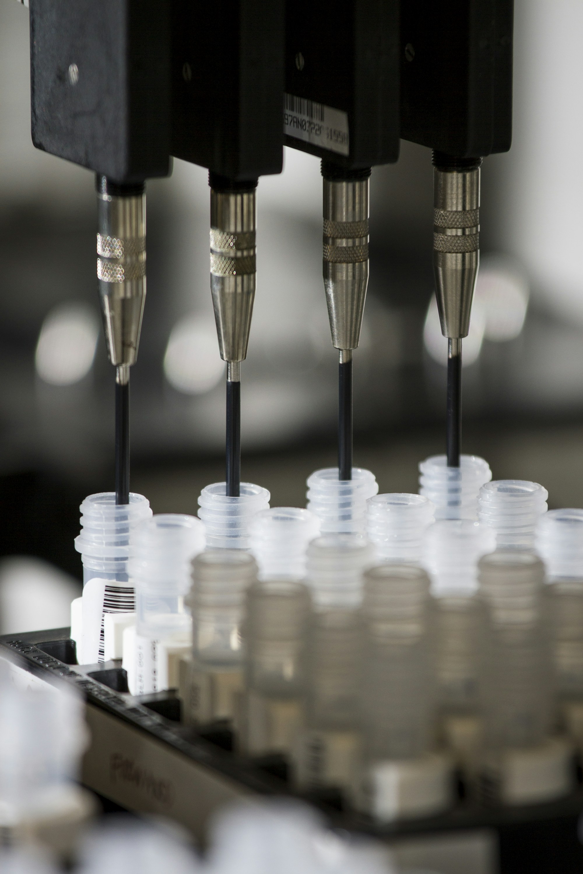 Close view of automated dispensing needles and sample vials